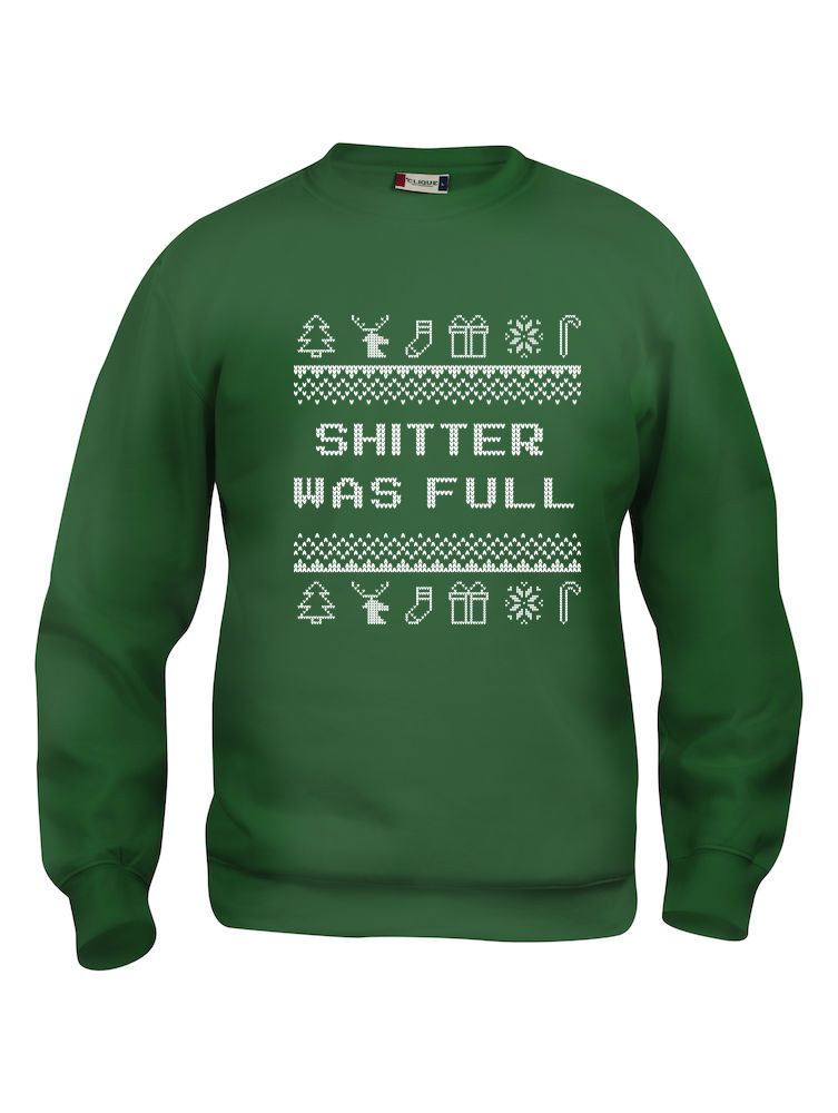 Grønn genser med sitat fra "Hjelp, det er juleferie", "Shitter was full"